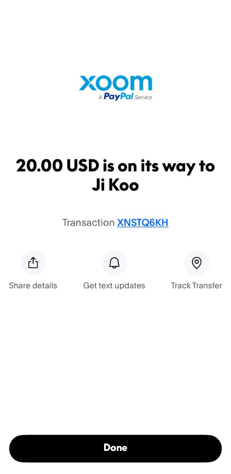 Xoom (a PayPal Service) confirmation screen showing 20.00 USD is on its way with a transaction ID